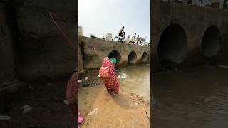 A woman catches fish from a large dam with a hook  amazing fishing in the canal  fishing shorts [upl. by Valerye]