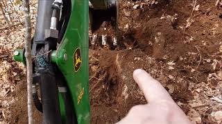 More stump removal John Deere 1023E TLB with 260 backhoe [upl. by Limoli]