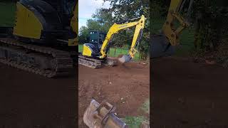 making a lawn yanmar vio55 levelling topsoil [upl. by Zoilla]