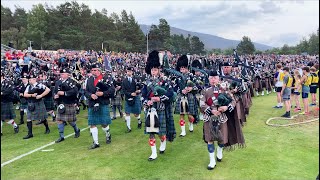 Massed Pipe Bands marching around Highland Games field during 2022 Braemar Gathering in Scotland [upl. by Cooley]