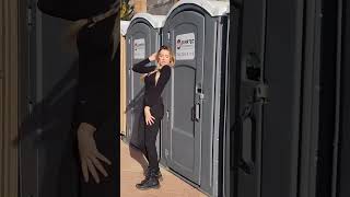 Influencer posing against porta potty get hit by door when occupant kicks it open [upl. by Gurl]