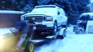 John Deere lawn tractor pulls F350 Dually in snow [upl. by Ahsetra]