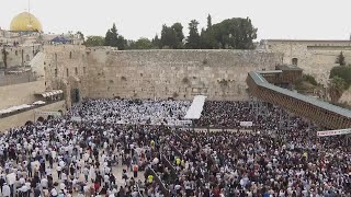 Jewish worshippers gather at Jerusalems Wailing Wall for the traditional priestly blessing prayer [upl. by Enileuqkcaj104]