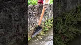 The process of removing moss from cement ditch wall with steel shovel [upl. by Yarvis798]