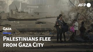 Gazans including evacuees from Shifa hospital flee from Gaza City  AFP [upl. by Ninazan]