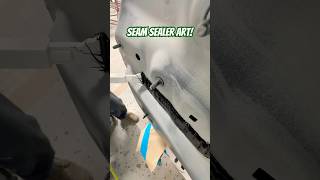 Laying seam sealer on this BMW after replacing the rear body panel seamsealer autobody collision [upl. by Yerocal]