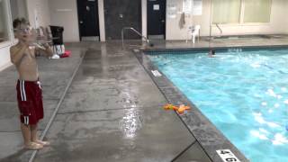 Skinny kid jumping through a childrens tube at the pool [upl. by Llerdnam49]