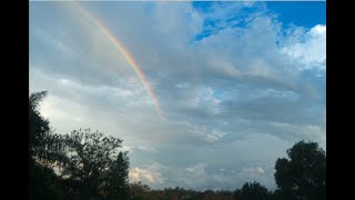 Clouds sun showers and rainbows timelapse [upl. by Norreg]