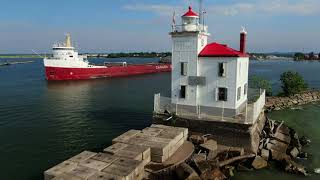 53 year old Great Lakes freighter Frontenac sails from Fairport Harbor by west breakwater lighthouse [upl. by Sonitnatsnoc541]