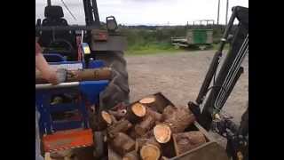 Loading Logs into trailer with quickie loader [upl. by Ahsla673]