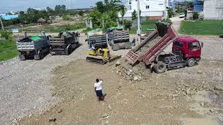 Truck dumping stone in the water to fill up land process with Komatsu Dozer push clear [upl. by Tsepmet847]