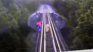 Women narrowly escape deathby diving under train while crossing US rail bridge [upl. by Revilo622]