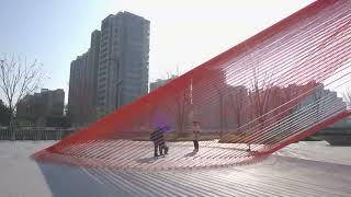 behin ha weaves temporary installation with orange mesh fabric ribbons at hangzhou complex [upl. by Andersen]