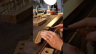 Installing guitar frets a very repetitive but satisfying process in Guitar Building luthier [upl. by Pollitt]