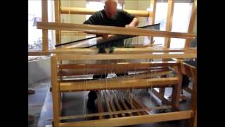 Using the reed to spread warp threads for loom weaving [upl. by Ysor]