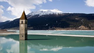 Alto Adige svuotato il lago di Resia riaffiorano i resti del borgo sommerso di Curon [upl. by Kruter]