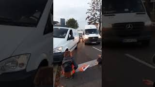 Van nearly hits ecoprotester as it mounts pavement to get past [upl. by Oidualc]